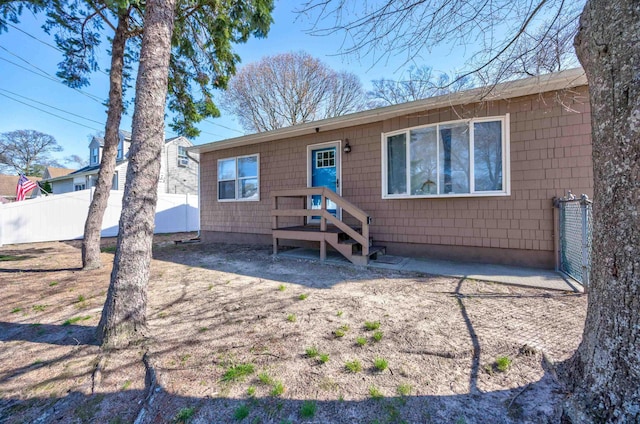 back of house with fence