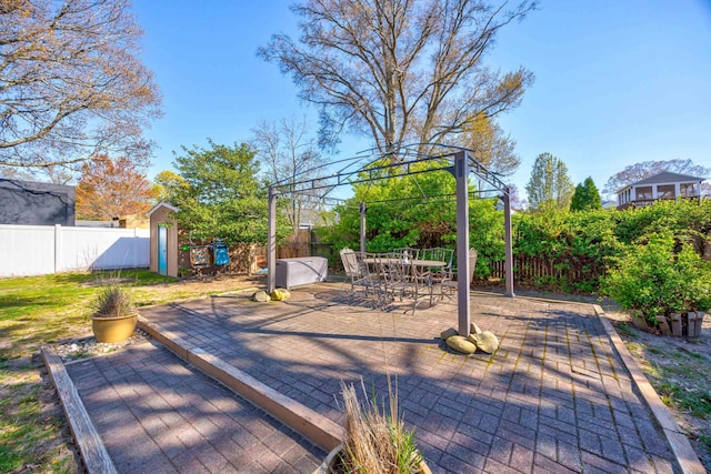 view of patio with a fenced backyard, an outdoor structure, and a storage shed