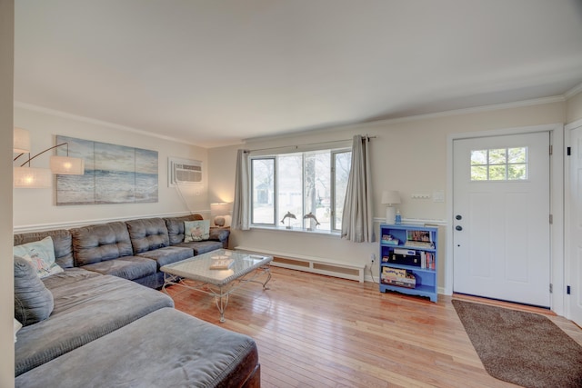 living room with a baseboard heating unit, light wood-style floors, plenty of natural light, and crown molding