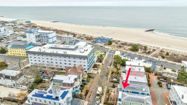 bird's eye view featuring a view of the beach and a water view