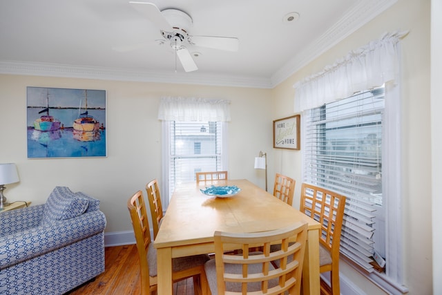 dining area with crown molding, hardwood / wood-style floors, and ceiling fan