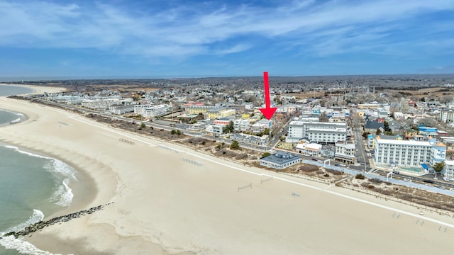 birds eye view of property with a beach view and a water view