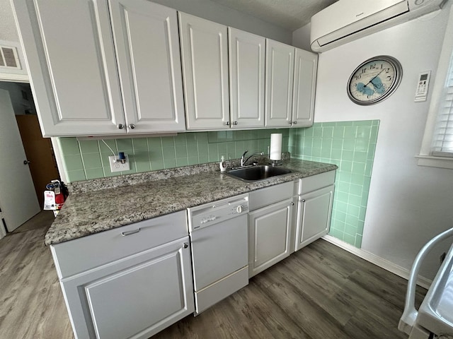 kitchen featuring an AC wall unit, white cabinetry, dishwasher, sink, and dark wood-type flooring