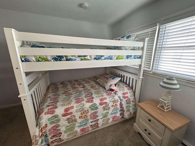 bedroom with dark colored carpet