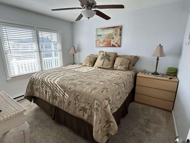 bedroom featuring ceiling fan, a baseboard radiator, and dark colored carpet