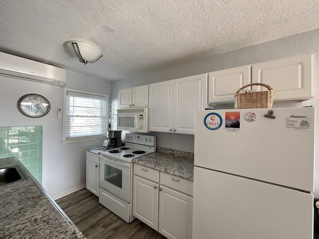 kitchen with white appliances, white cabinetry, dark hardwood / wood-style floors, a wall mounted AC, and a textured ceiling