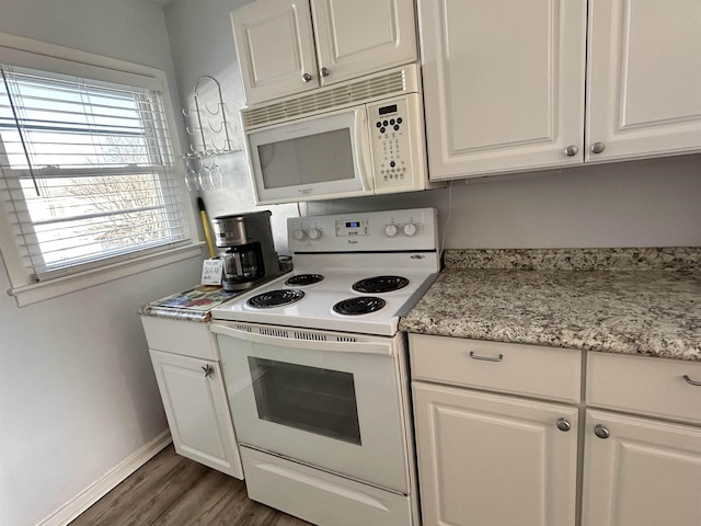 kitchen with dark hardwood / wood-style flooring, white cabinets, and white appliances