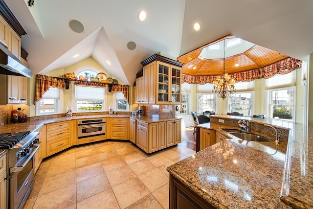 2404 Atlantic Ave, Longport, NJ 08403 - kitchen featuring appliances with stainless steel finishes, lofted ceiling, glass insert cabinets, a chandelier, and dark stone countertops