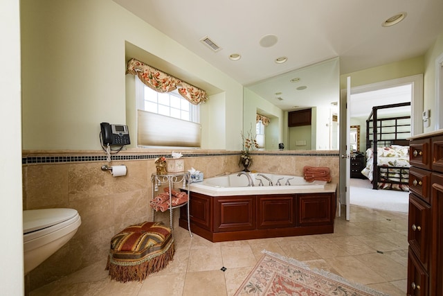 2404 Atlantic Ave, Longport, NJ 08403 - bathroom with tile walls, a bath, tile patterned flooring, a wainscoted wall, and recessed lighting