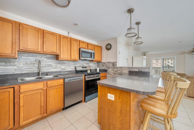 227 E Leaming Ave Unit A, Wildwood, NJ 08260 - kitchen with stainless steel appliances, a sink, dark countertops, and light tile patterned floors