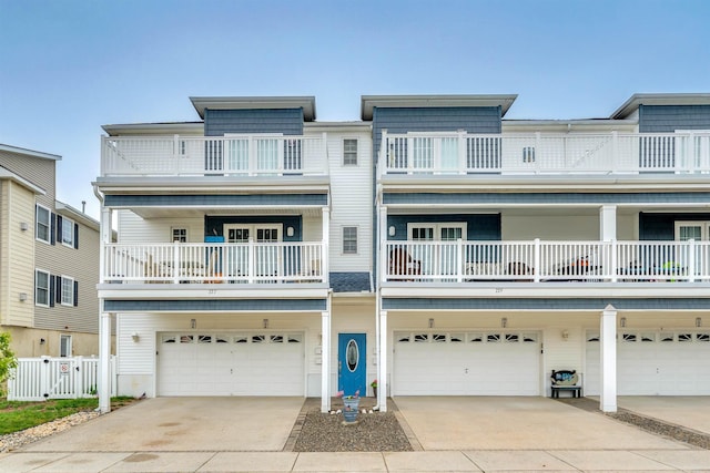 227 E Leaming Ave Unit A, Wildwood, NJ 08260 - view of front facade with a garage, fence, a balcony, and concrete driveway