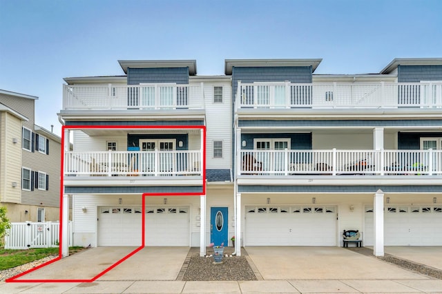 227 E Leaming Ave Unit A, Wildwood, NJ 08260 - view of property featuring a garage, fence, a balcony, and driveway