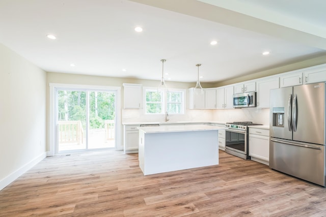 70 W Rising Sun Dr, Ocean View, NJ 08230 - kitchen featuring appliances with stainless steel finishes, light countertops, white cabinetry, recessed lighting, and a center island