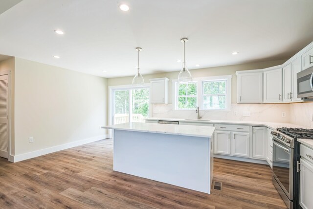 70 W Rising Sun Dr, Ocean View, NJ 08230 - kitchen with stainless steel appliances, a kitchen island, recessed lighting, tasteful backsplash, and wood finished floors