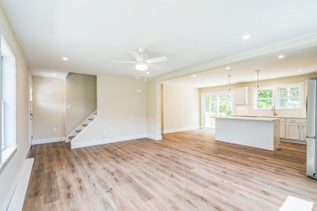 70 W Rising Sun Dr, Ocean View, NJ 08230 - unfurnished living room featuring light wood finished floors, stairs, a ceiling fan, and recessed lighting