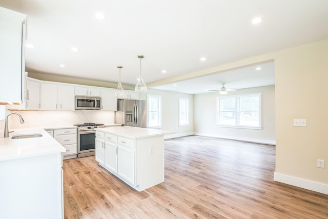 70 W Rising Sun Dr, Ocean View, NJ 08230 - kitchen with appliances with stainless steel finishes, white cabinetry, recessed lighting, a kitchen island, and light countertops
