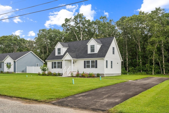 70 W Rising Sun Dr, Ocean View, NJ 08230 - cape cod house featuring a front yard, roof with shingles, and view of scattered trees