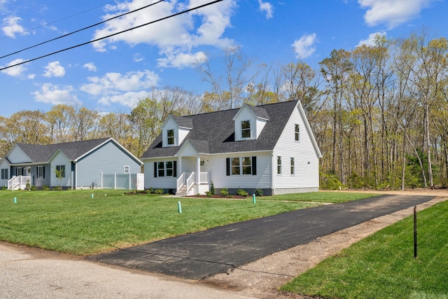 70 W Rising Sun Dr, Ocean View, NJ 08230 - new england style home with a front lawn and roof with shingles
