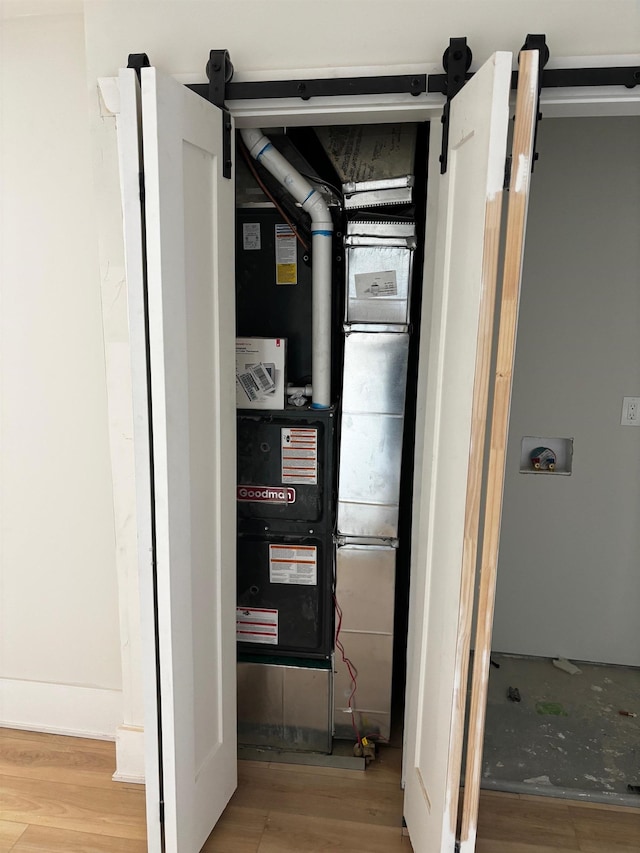 utility room featuring heating unit