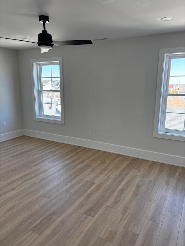 spare room with light hardwood / wood-style floors and ceiling fan