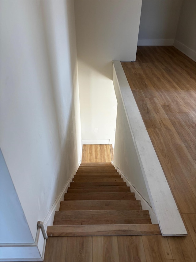 stairs featuring hardwood / wood-style flooring