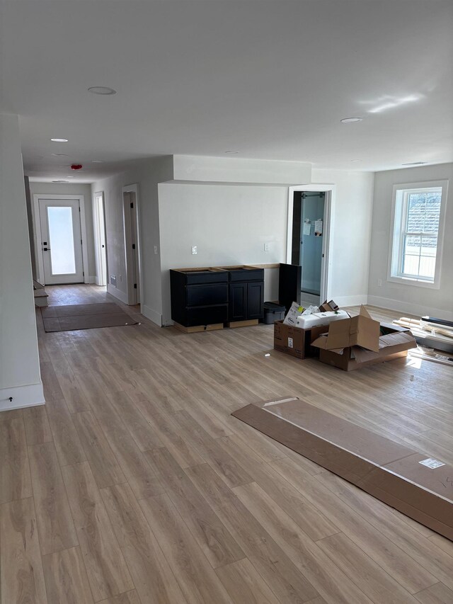 unfurnished living room with wood-type flooring