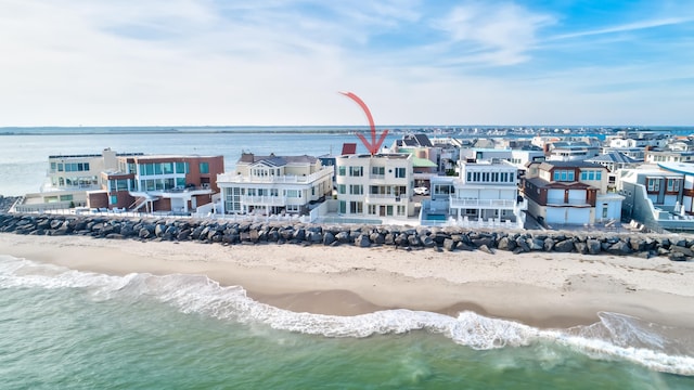 aerial view with a water view and a beach view