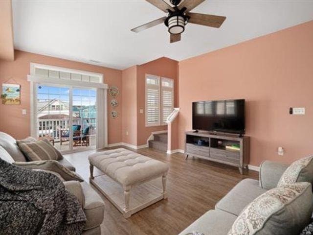 living room featuring hardwood / wood-style floors and ceiling fan