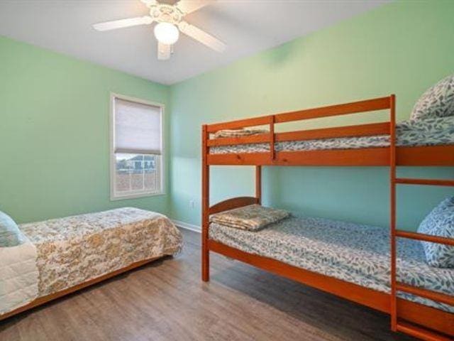 bedroom featuring ceiling fan and wood-type flooring