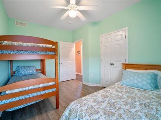 bedroom featuring hardwood / wood-style floors and ceiling fan