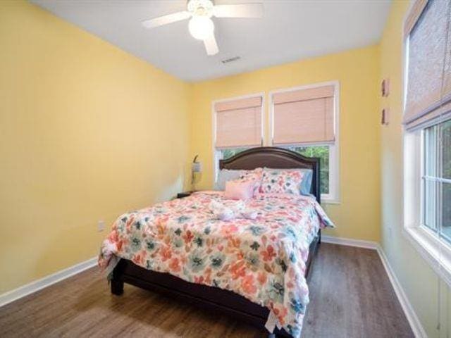 bedroom with dark wood-type flooring and ceiling fan