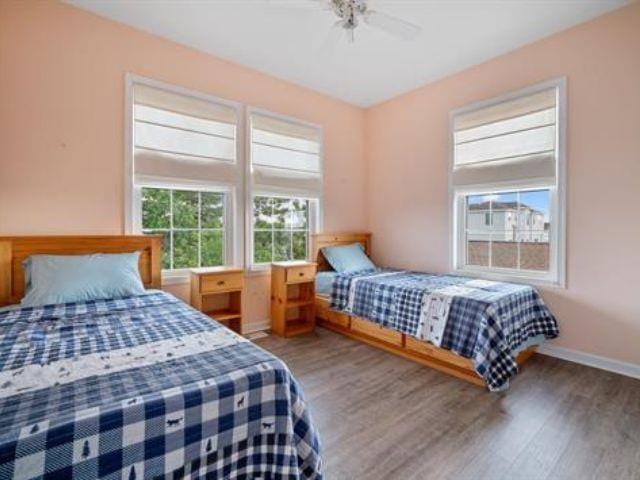 bedroom with ceiling fan and dark hardwood / wood-style flooring