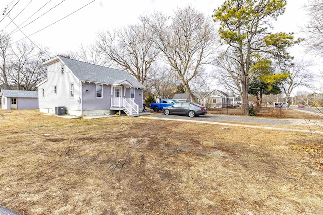 1025 Rte 47 S, Rio Grande, NJ 08204 - view of home's exterior with central AC unit, a shingled roof, and a yard