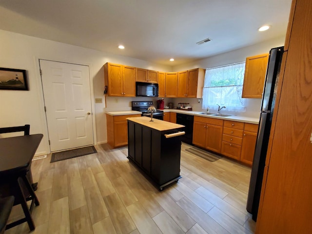 20 Summer Cir, North Cape May, NJ 08204 - kitchen featuring black appliances, light countertops, a sink, a center island, and recessed lighting