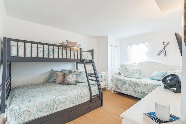 bedroom featuring light wood-style flooring and a closet