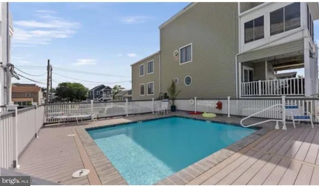 community pool featuring a wooden deck