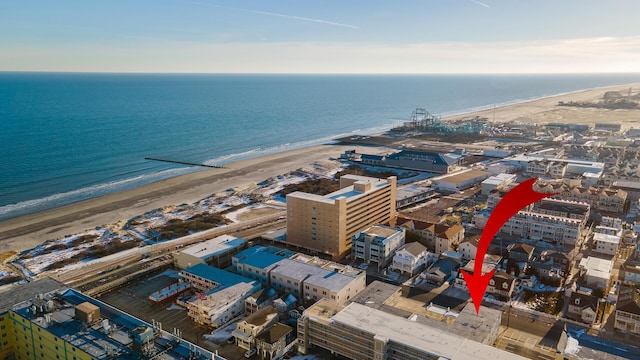 drone / aerial view with a water view and a view of the beach