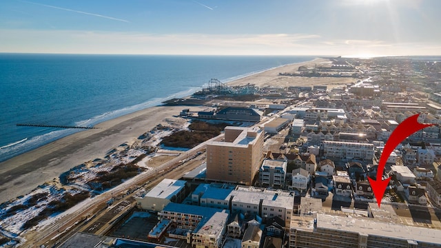 bird's eye view featuring a view of the beach and a water view