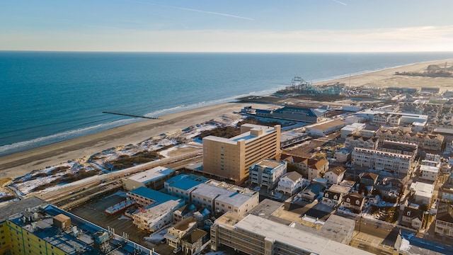 drone / aerial view with a beach view and a water view