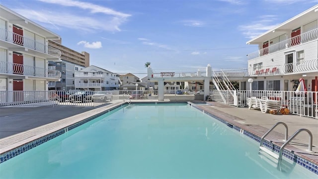 community pool featuring a patio area and fence