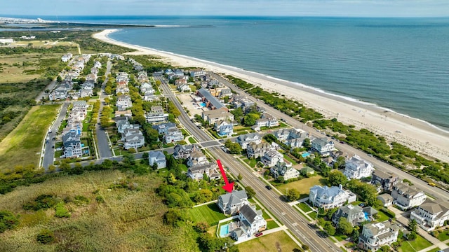 drone / aerial view featuring a view of the beach and a water view