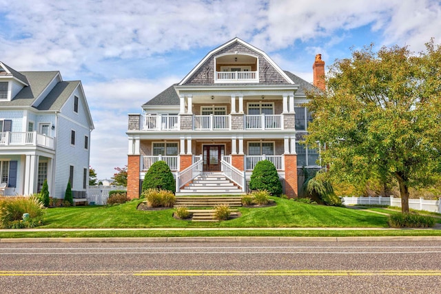 view of front facade with covered porch and a front lawn