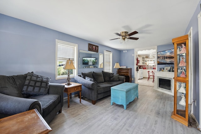 living room featuring light hardwood / wood-style floors and ceiling fan