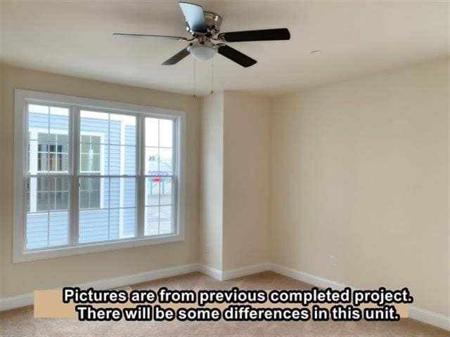 carpeted empty room featuring ceiling fan