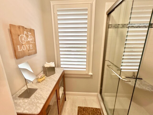847 Broadway Unit 8, West Cape May, NJ 08204 - bathroom with a stall shower, baseboards, and vanity