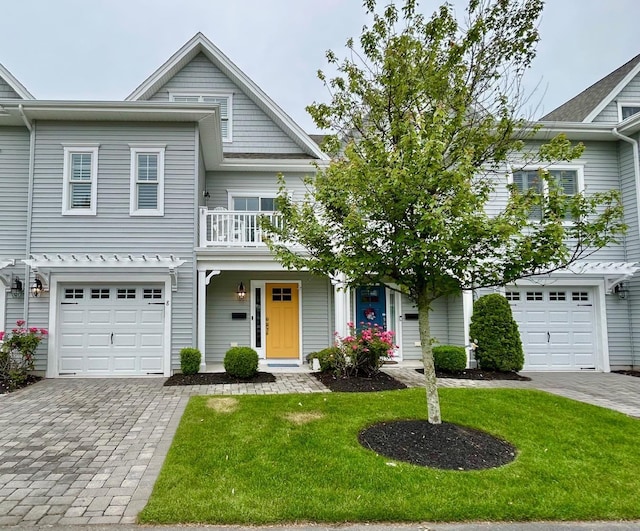 847 Broadway Unit 8, West Cape May, NJ 08204 - view of front of house with a garage, decorative driveway, a front lawn, and a balcony