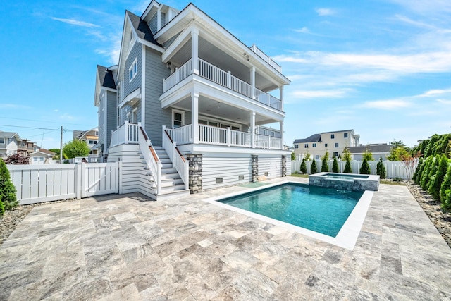 286 75th St, Avalon, NJ 08202 - rear view of house with a balcony, a fenced backyard, a gate, and a patio