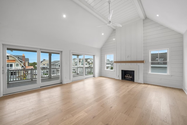 286 75th St, Avalon, NJ 08202 - unfurnished living room with wood finished floors, beamed ceiling, a large fireplace, ceiling fan, and high vaulted ceiling