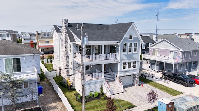 286 75th St, Avalon, NJ 08202 - rear view of house with roof with shingles, a garage, a balcony, stairway, and driveway