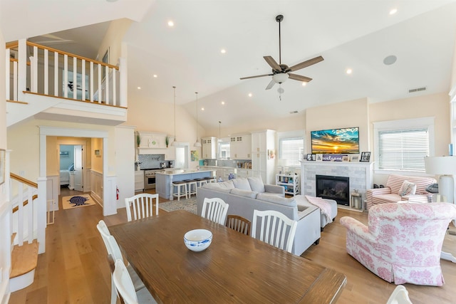 149 10th St, Avalon, NJ 08202 - dining room featuring healthy amount of natural light, stairway, ceiling fan, light wood-type flooring, and high vaulted ceiling